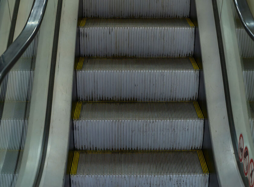 Symmetrical Escalator Steps Ascending Towards Progress And Success. Urban Escalator In Motion Capturing The Essence Of Modern Transportation. Concept image.